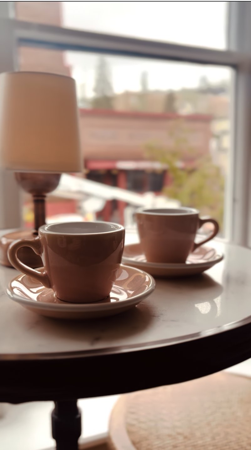 Two cups of cocoa by the window over Main Street