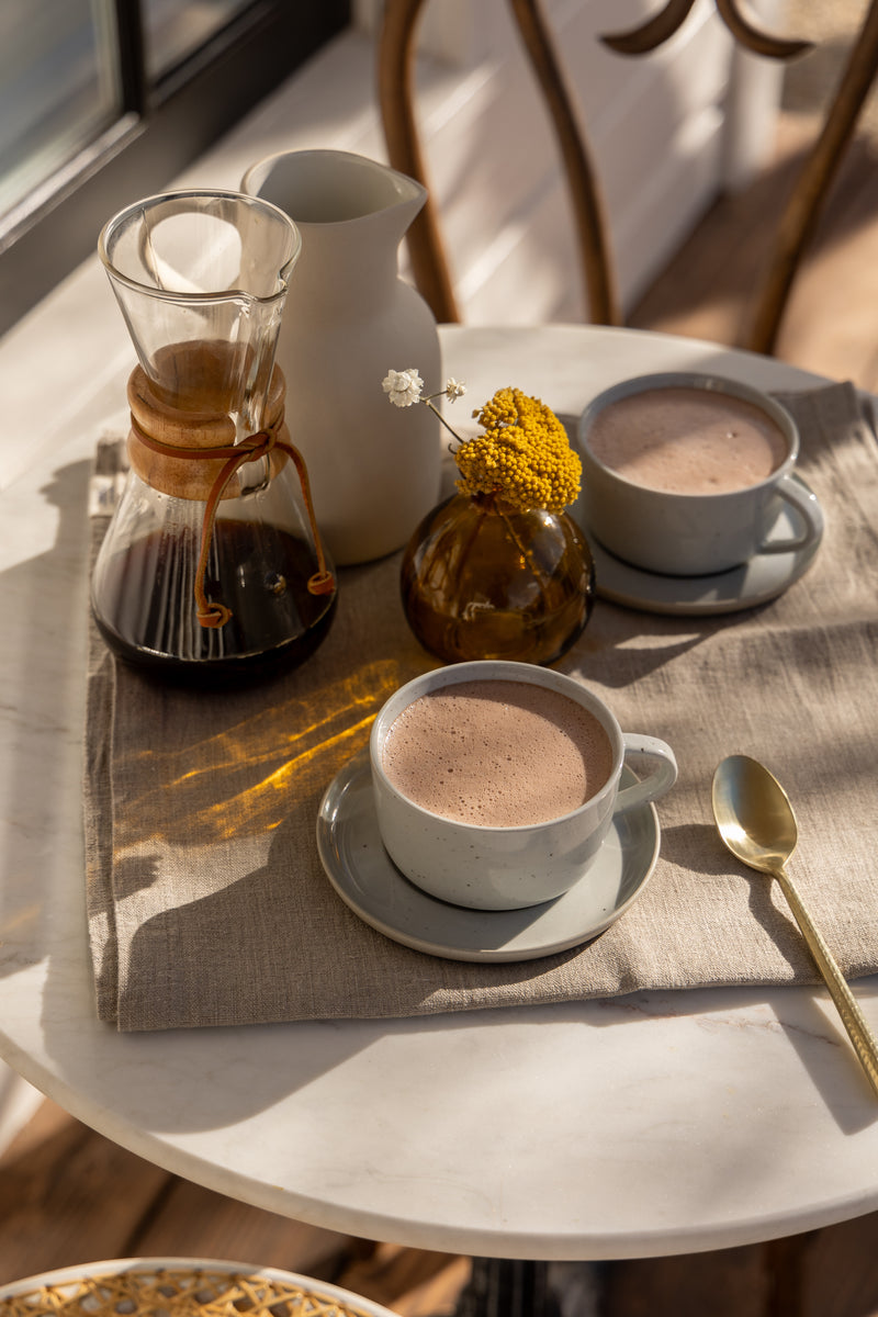 Two cups of LOCOCO on a tray beside a pour-over coffee