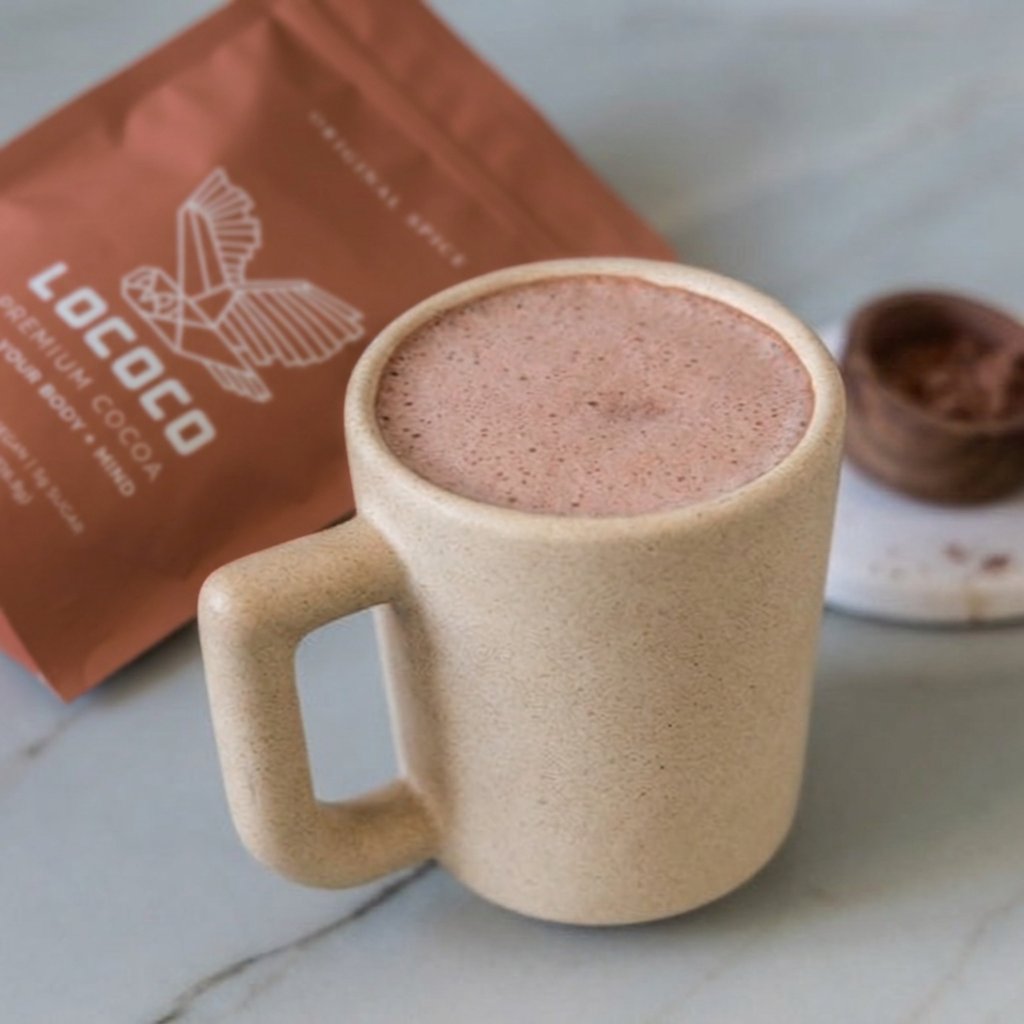 A frothy cup of LOCOCO beside the bag
